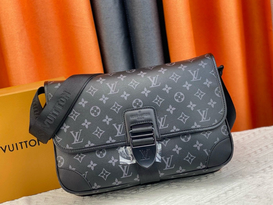 Louis Vuitton monogram handbag on a surface with an orange curtain in the background