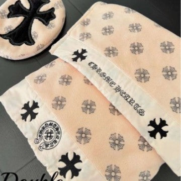 Beige fabric with black floral and cross patterns on a dark surface