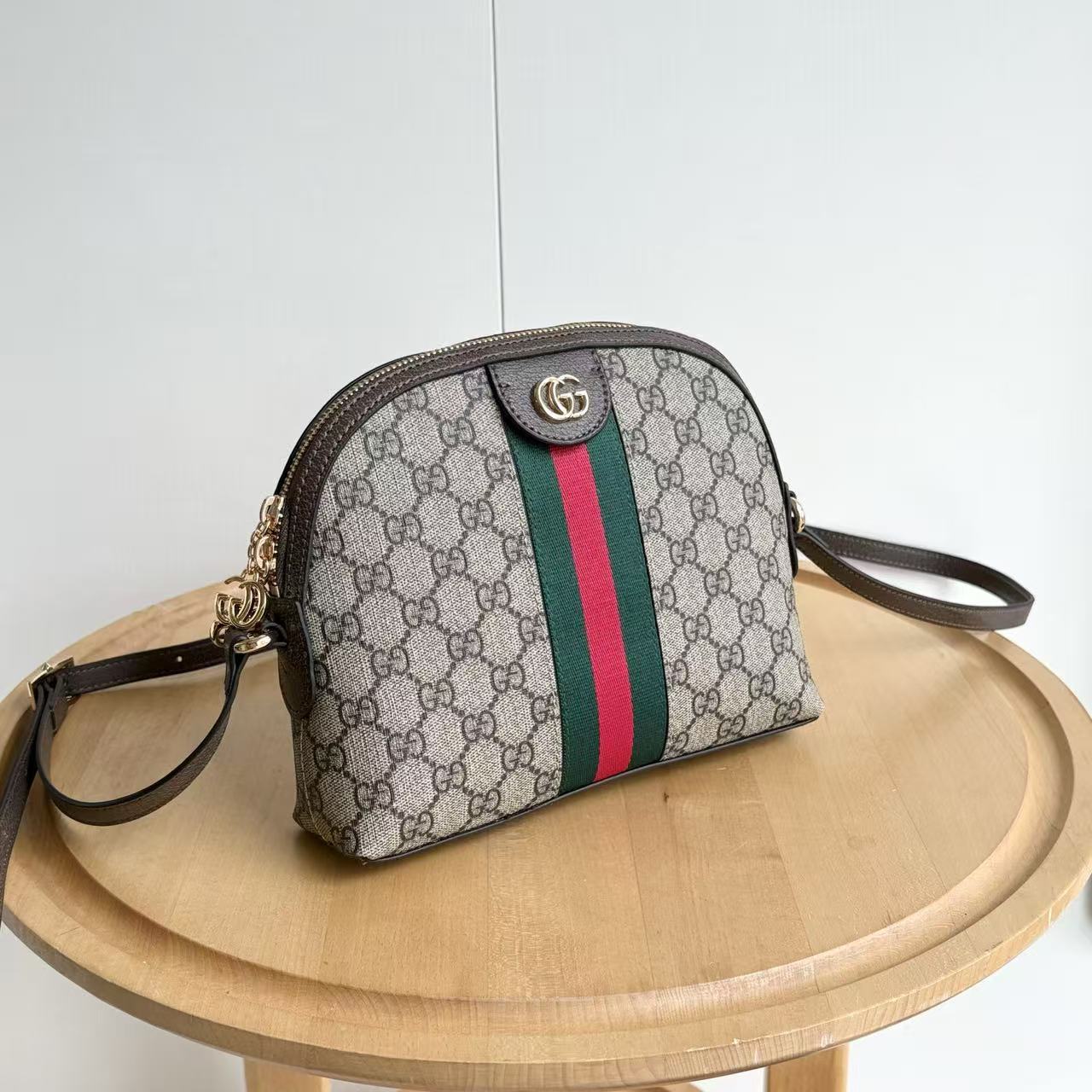 Designer handbag with a distinctive pattern on a wooden surface