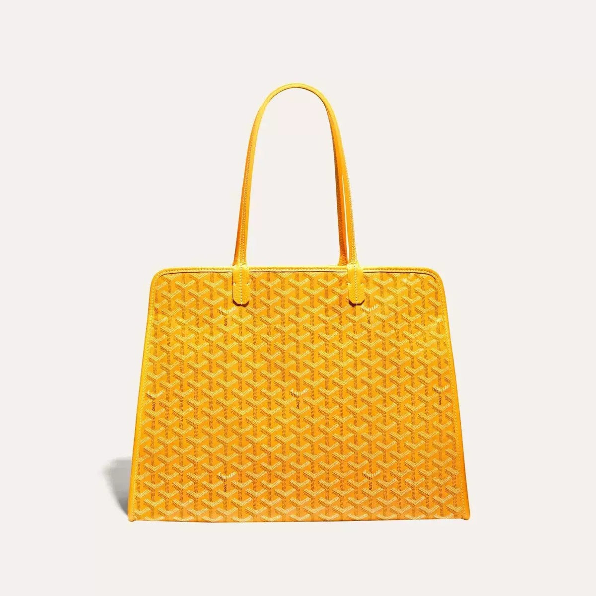 Yellow handbag with a textured pattern on a light gray background