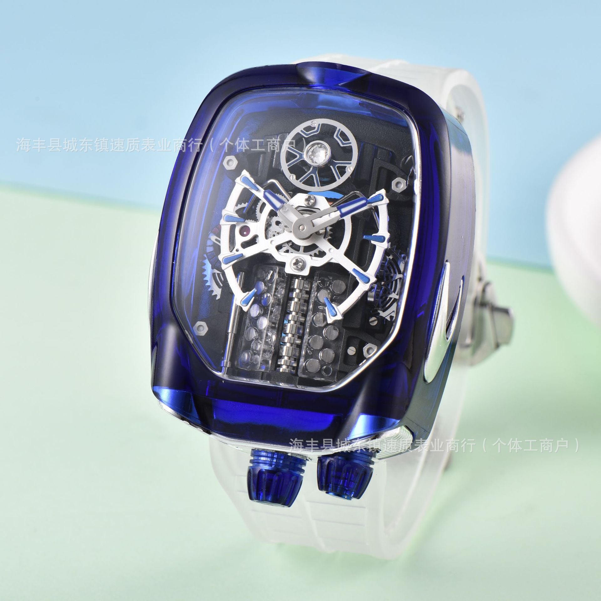 Blue and transparent mechanical watch on a light green background