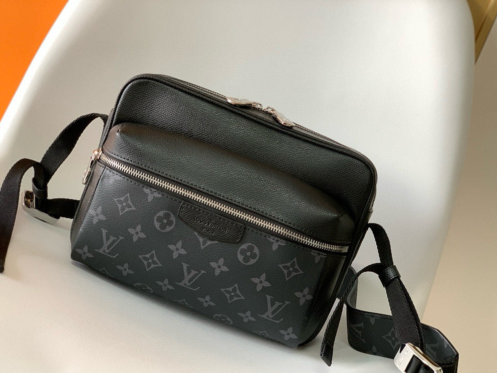 Black leather bag with monogram pattern on a white surface