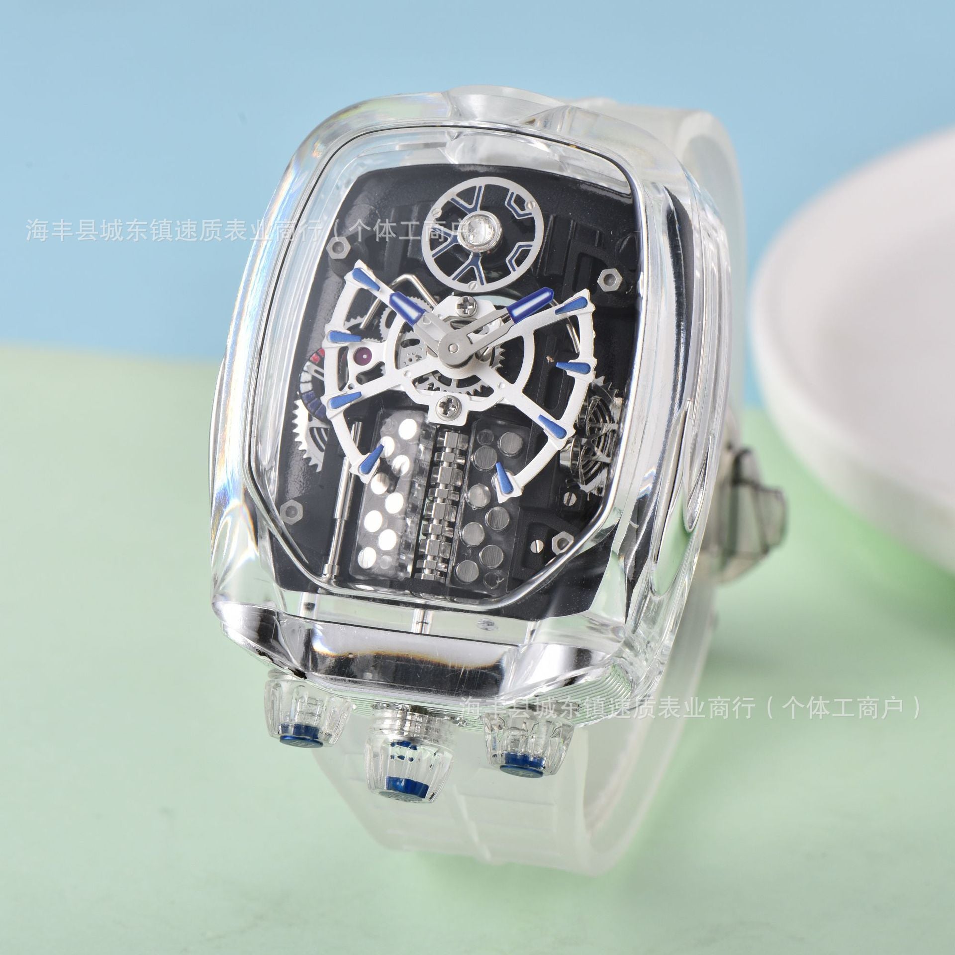 Transparent mechanical watch with visible gears on a light green background