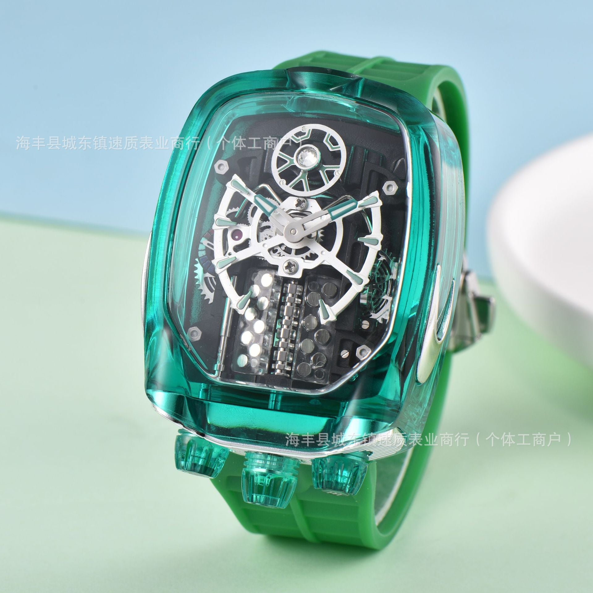 Green wristwatch with transparent case on a light blue and green gradient background
