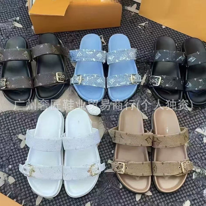 Various pairs of sandals in different colors on a textured surface.