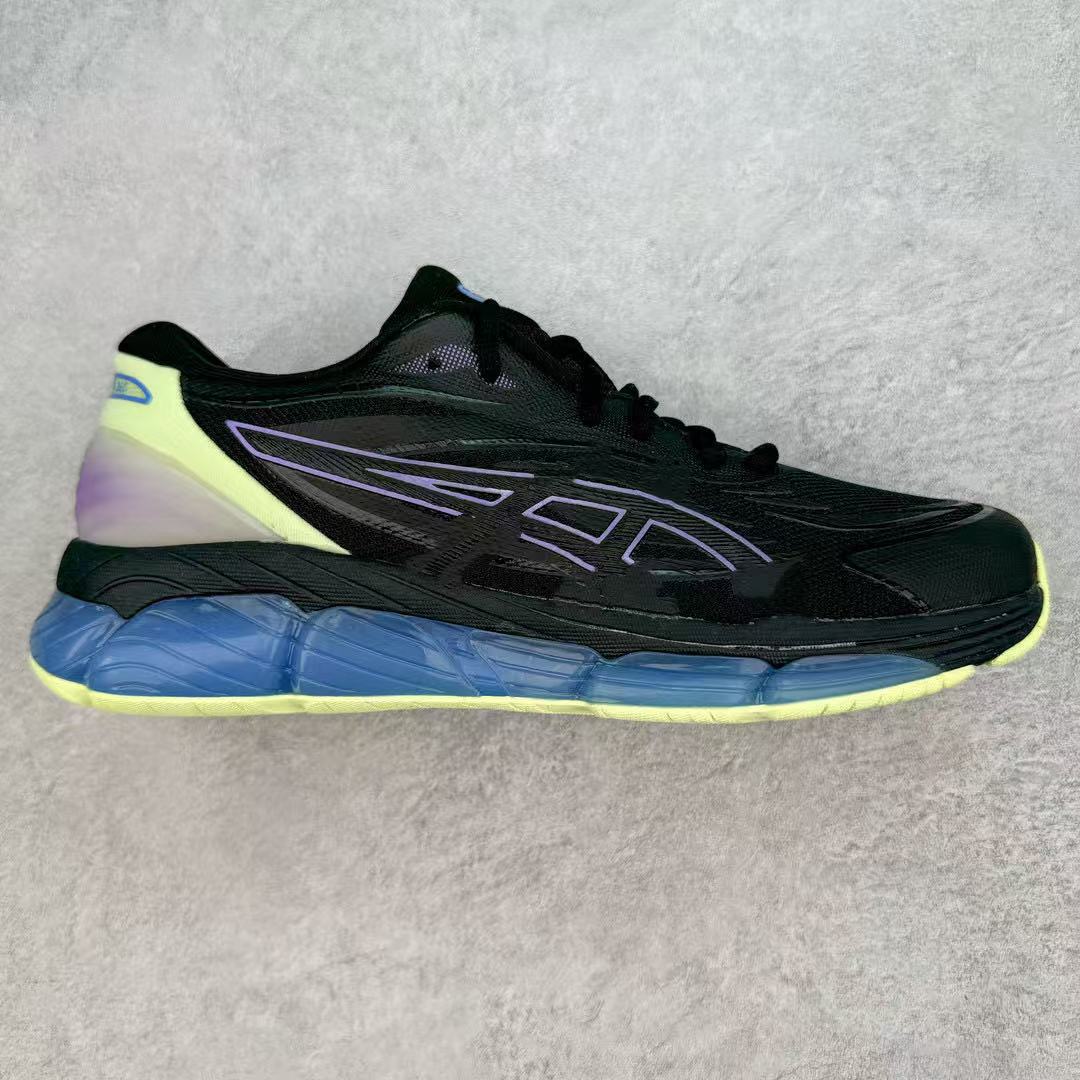 Black running shoe with blue sole on a gray background