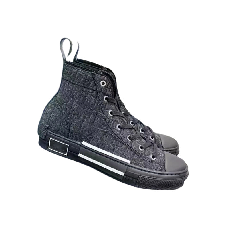 A pair of high-top sneakers in a dark gray and black textured monogram canvas, featuring a rubber toe cap, black laces, and a white stripe detail on the side of the sole.