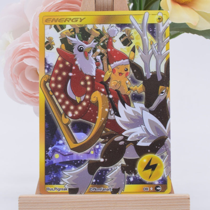 A Pokémon trading card featuring Pikachu and a deer in a sleigh, displayed upright on a small wooden stand with soft pink flowers in the background.