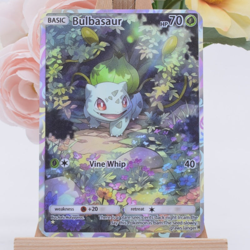 A holographic Pokémon Bulbasaur trading card displayed on a small wooden stand, with pink and yellow flowers blurred in the background.
