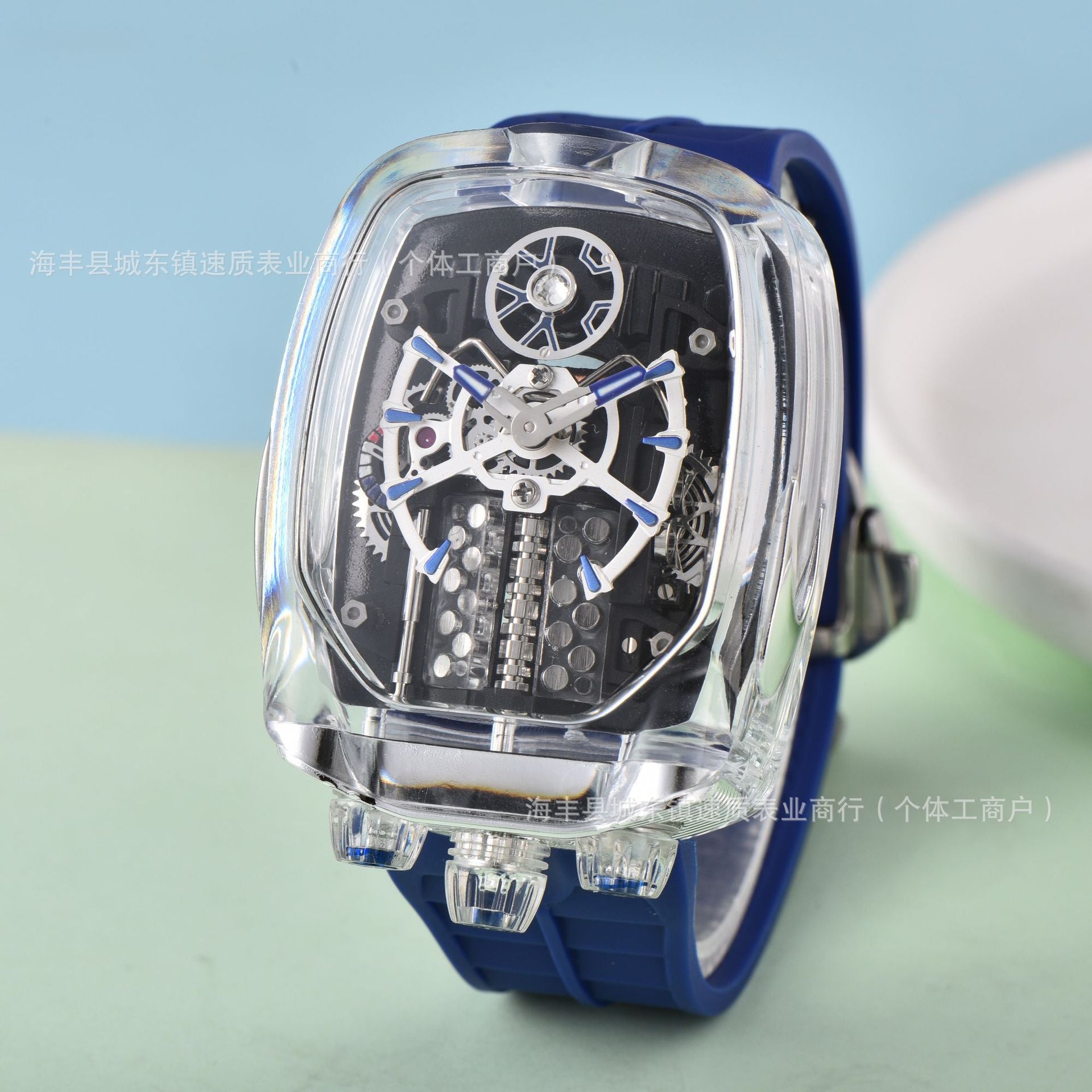 Watch with transparent case and blue strap on a light blue background
