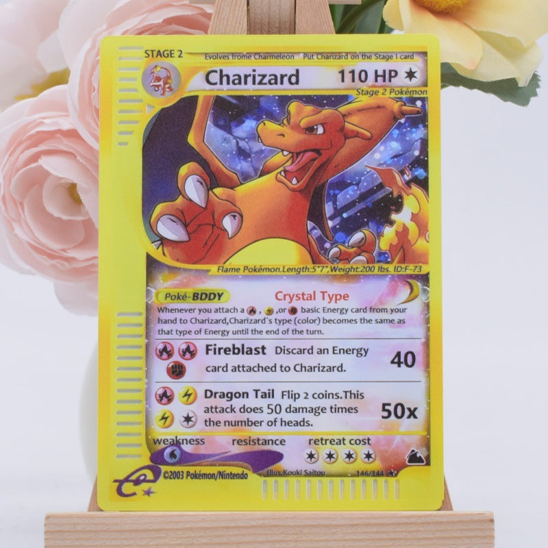 A Charizard Pokémon trading card displayed upright on a small wooden stand, with soft pink and yellow flowers blurred in the background.
