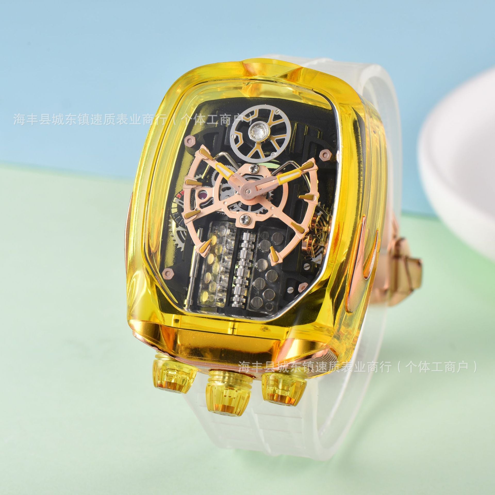 Gold mechanical watch with transparent case on a light blue and green gradient background