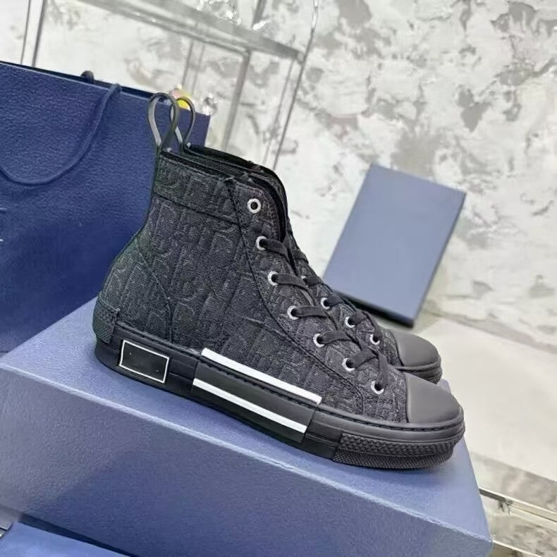 Black high-top sneaker with patterned design on a blue box