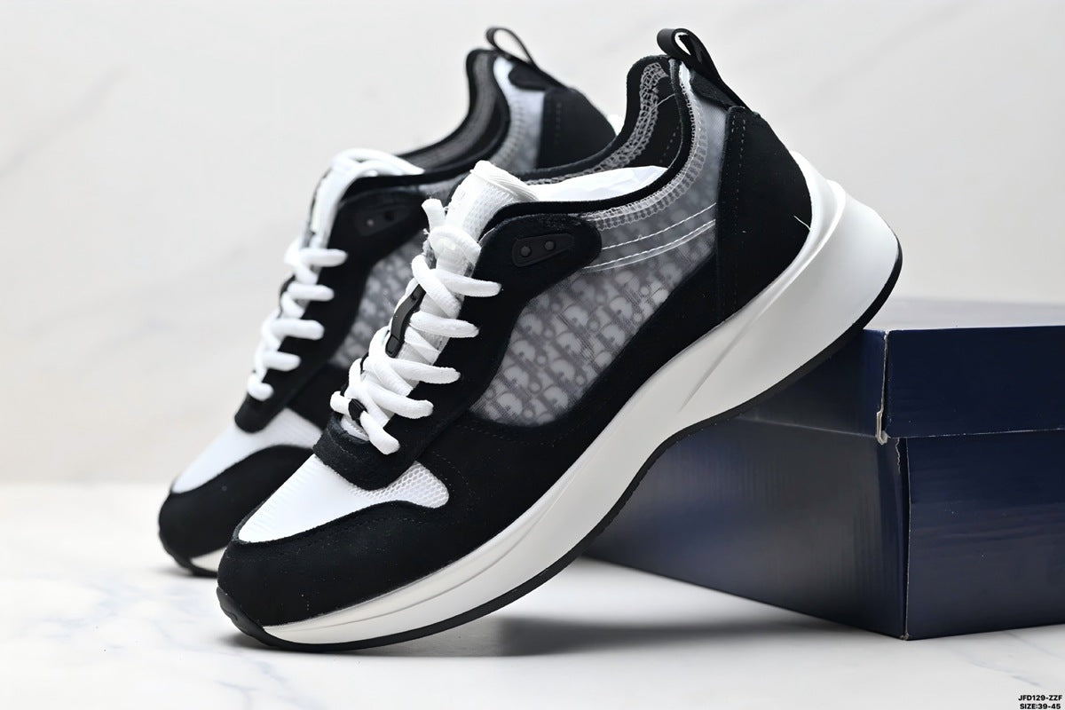 Black and white sneakers with a brand logo on a light gray background