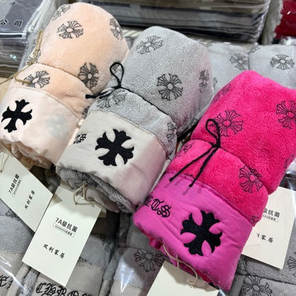 Set of folded towels with floral patterns on a white background