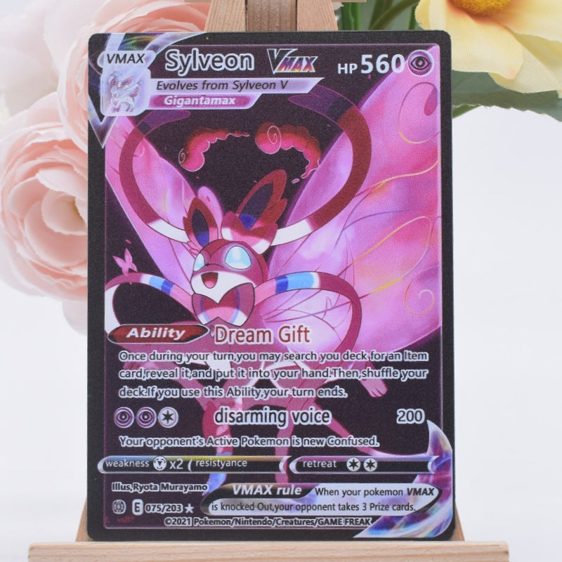 A holographic Pokémon trading card of Sylveon VMAX from the Scarlet & Violet expansion, displayed on a small wooden stand with pink roses in the background.