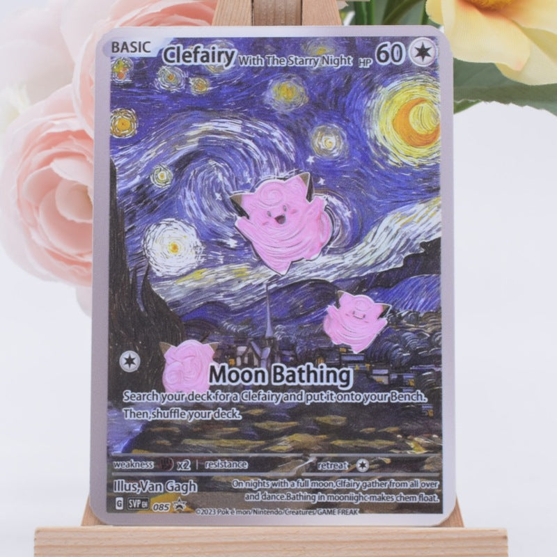 A Pokémon trading card featuring Clefairy in a Van Gogh-style starry night scene with pink moon shapes, displayed upright on a small wooden stand with soft pink and yellow flowers blurred in the background.