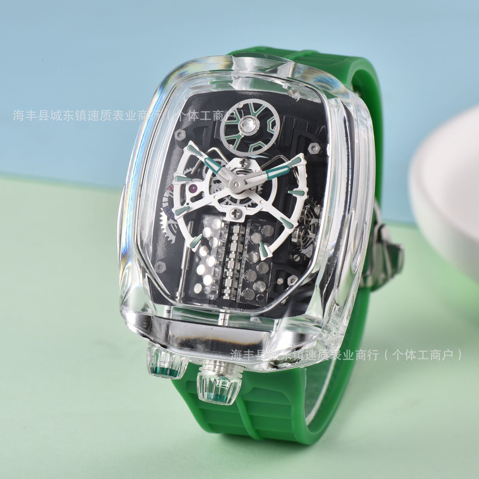 Watch with transparent case and green strap on a light blue and green gradient background