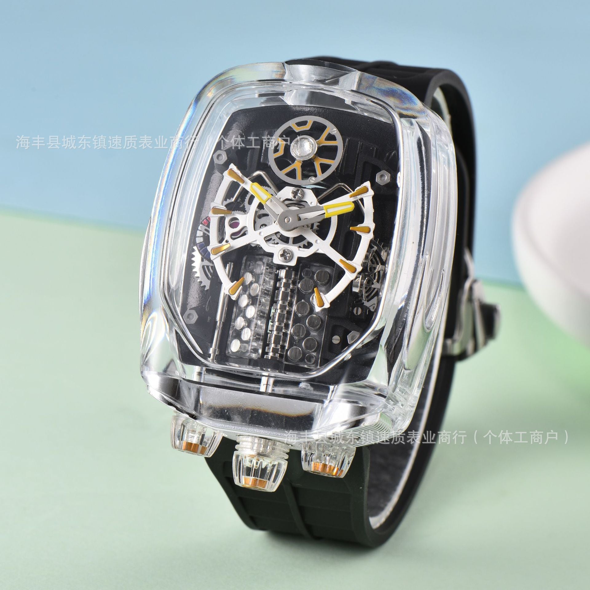 Watch with transparent case and black strap on a light blue and green gradient background