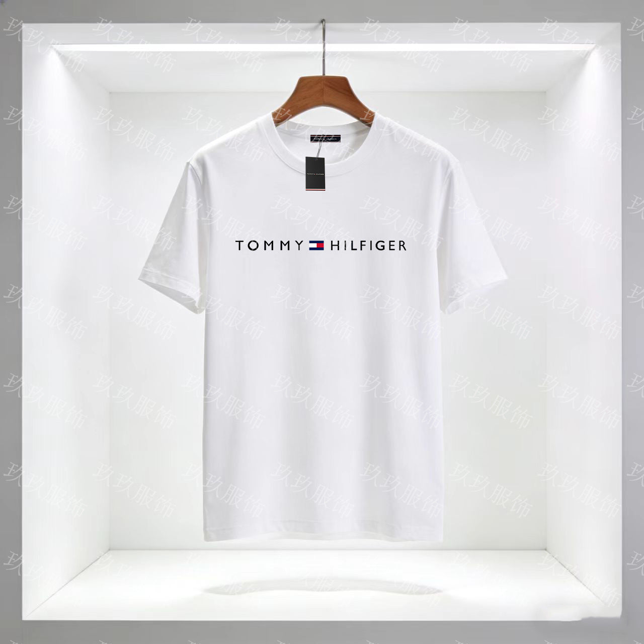 White Tommy Hilfiger t-shirt on a hanger with a clear background