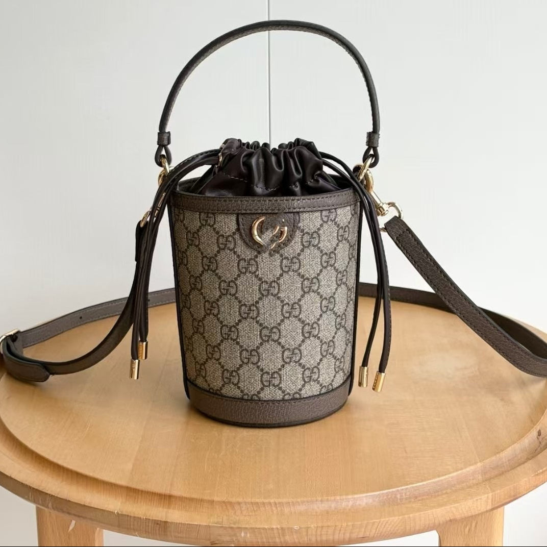 Designer handbag with monogram pattern on a wooden table