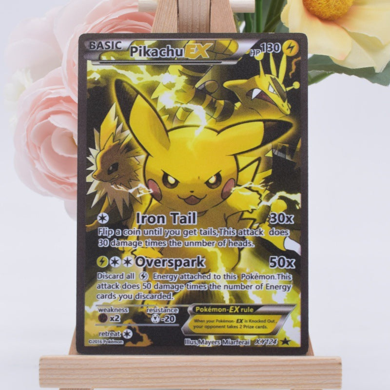 A Pokémon EX trading card featuring Pikachu, displayed upright on a small wooden easel with pink and yellow flowers blurred in the background.