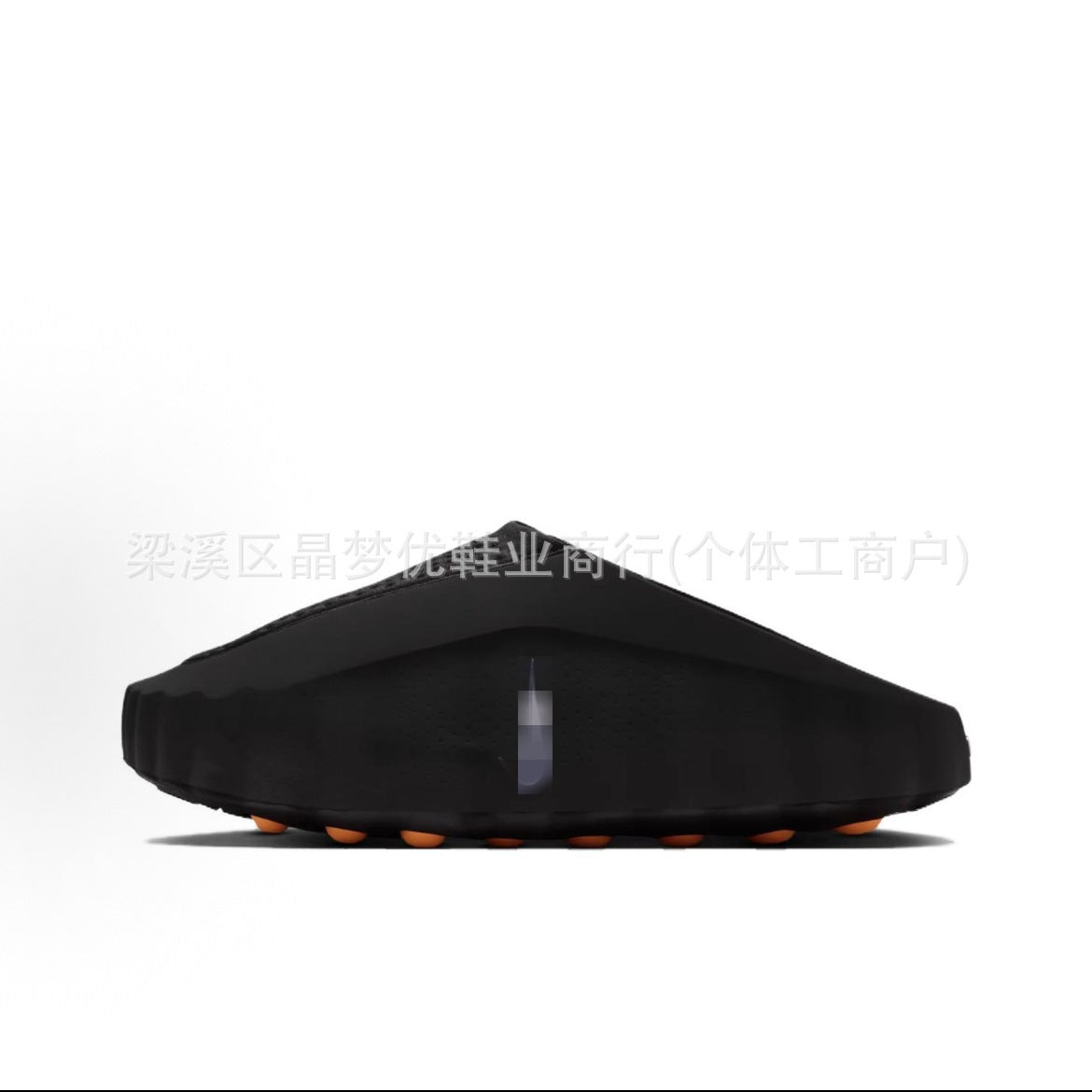 Black shoe sole with orange accents on a white background