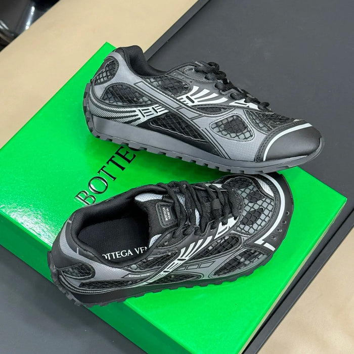 Black and gray athletic shoes on a green box with 'Bottega' branding.