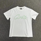 White t-shirt with green text on a plain background