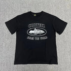 Black t-shirt with white graphic and text on a gray textured background