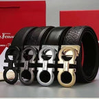 Black leather belts with gold, silver, and black buckles on a red background
