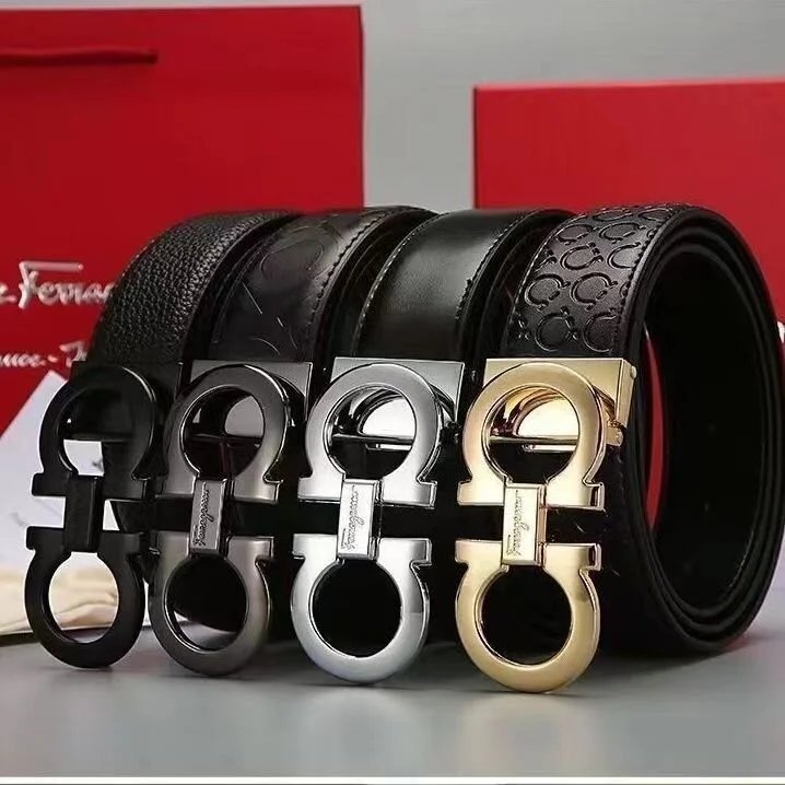 Black leather belts with gold, silver, and black buckles on a red background