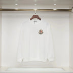 White long-sleeve shirt with a logo on a hanger against a white background