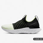 Black and white sneaker with green accents on a light gray background