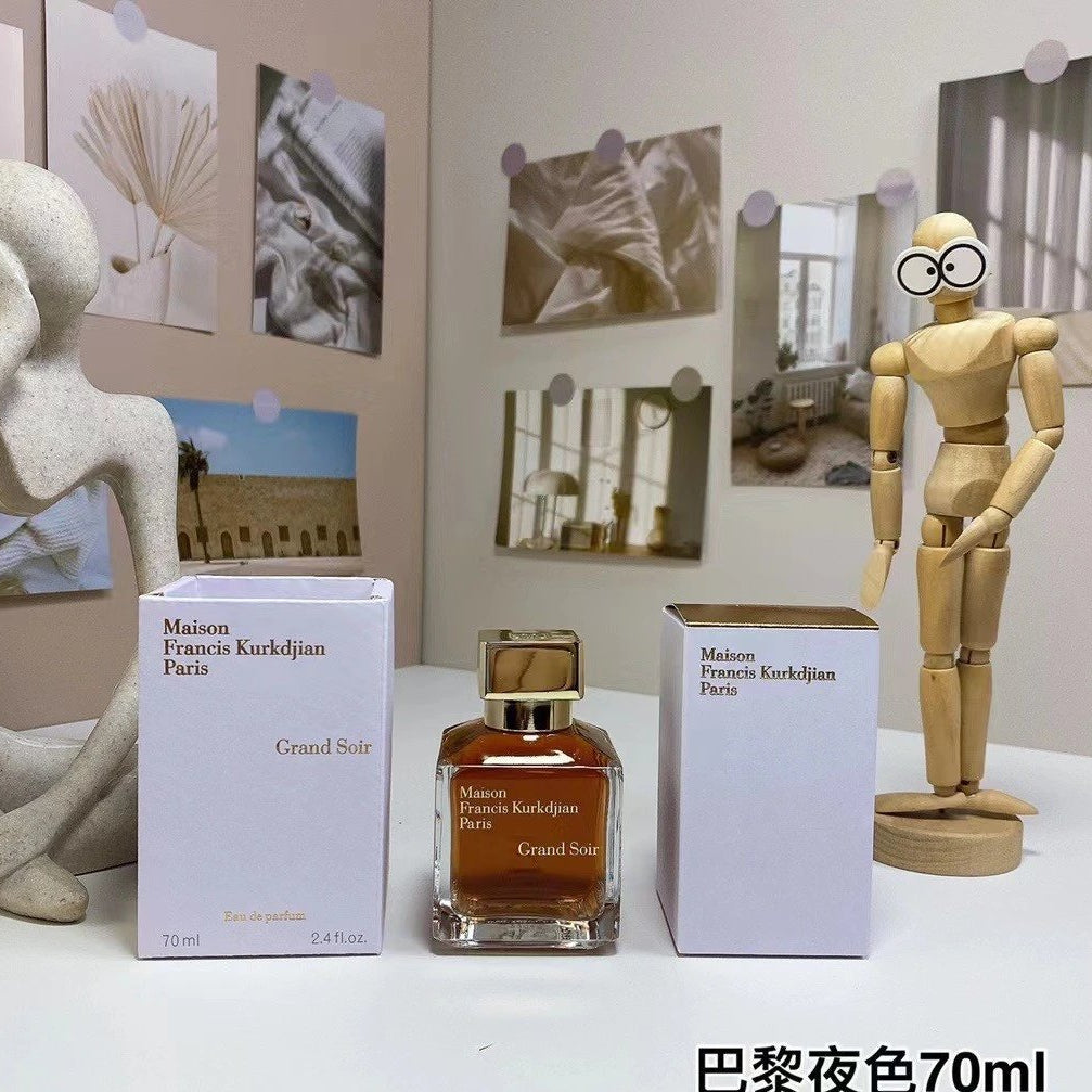 Perfume bottle and packaging on a table with decorative items in the background