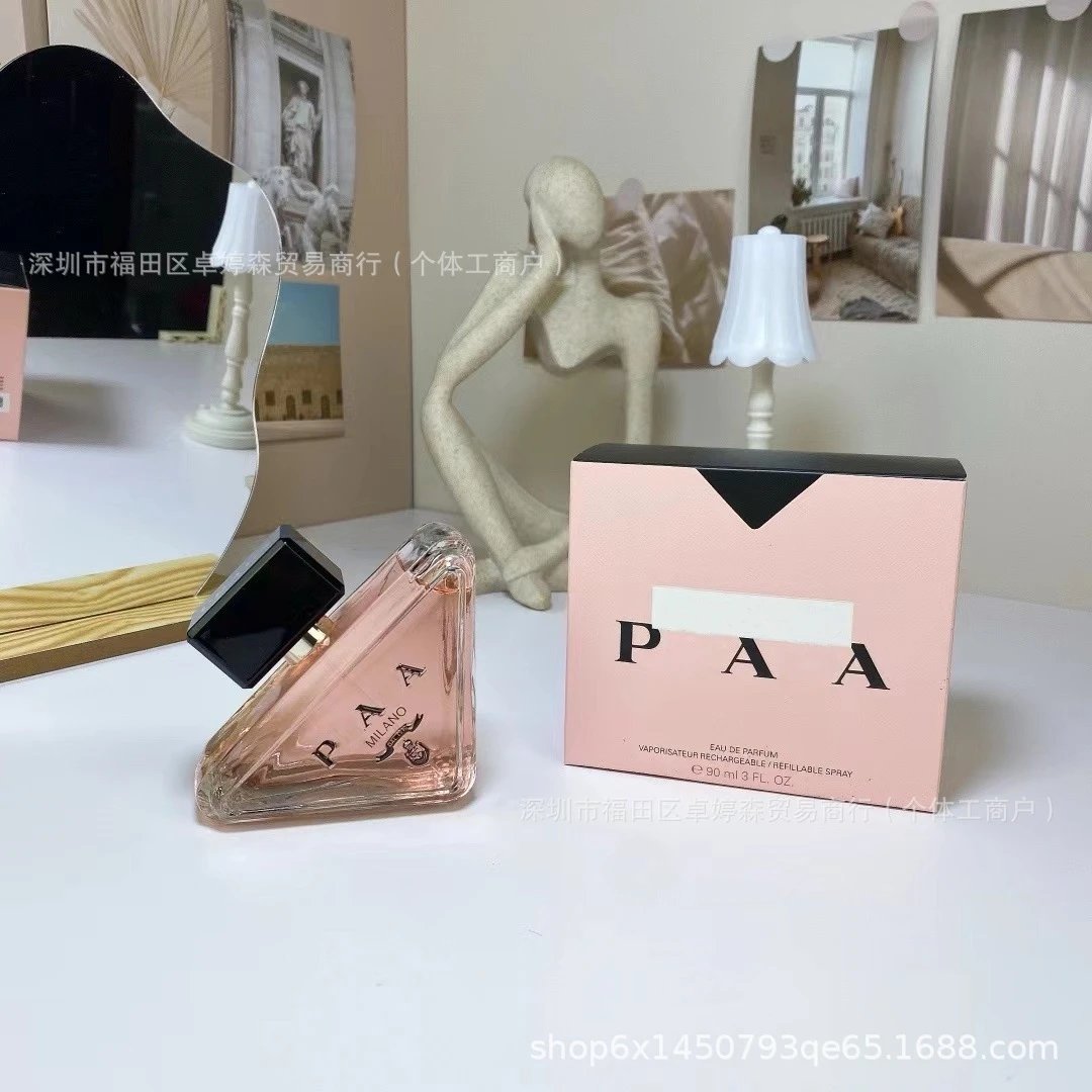 Perfume bottle and packaging with 'PAA' branding on a white surface.