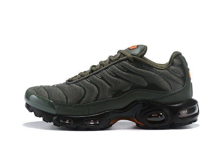 Green sneaker with black sole on a white background