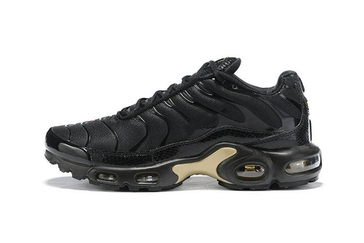 Black Nike sneaker with gold accents on a white background