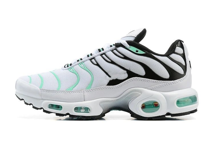 White sneaker with black and green accents on a white background