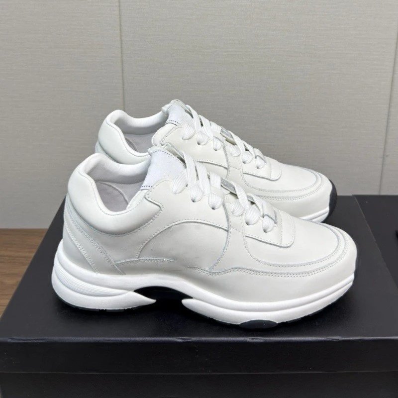 White sneakers on a black surface with a gray background
