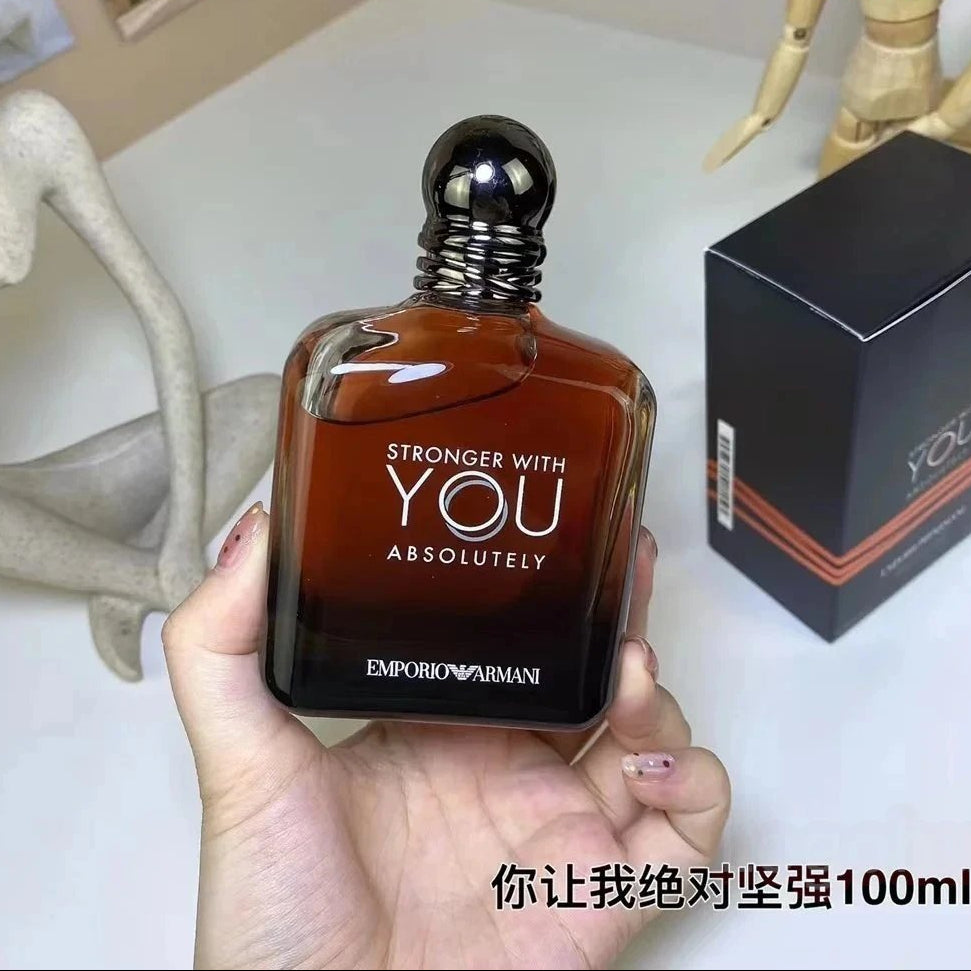 Emporio Armani perfume bottle held in a hand with packaging in the background