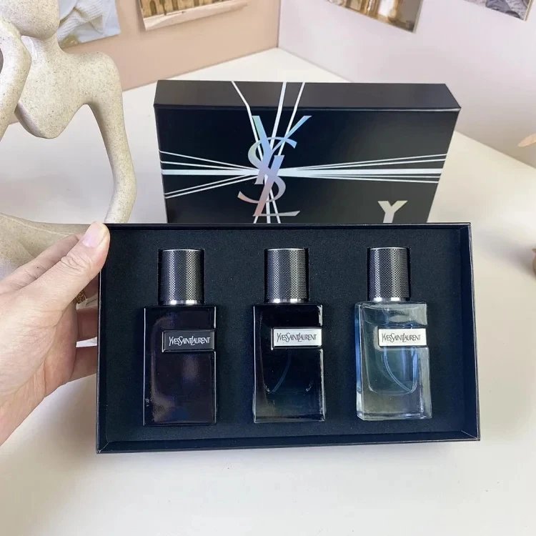 YSL perfume set with three bottles in a black box on a white surface.