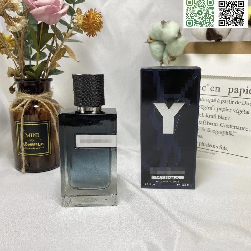Perfume bottle and packaging with flowers and paper in the background