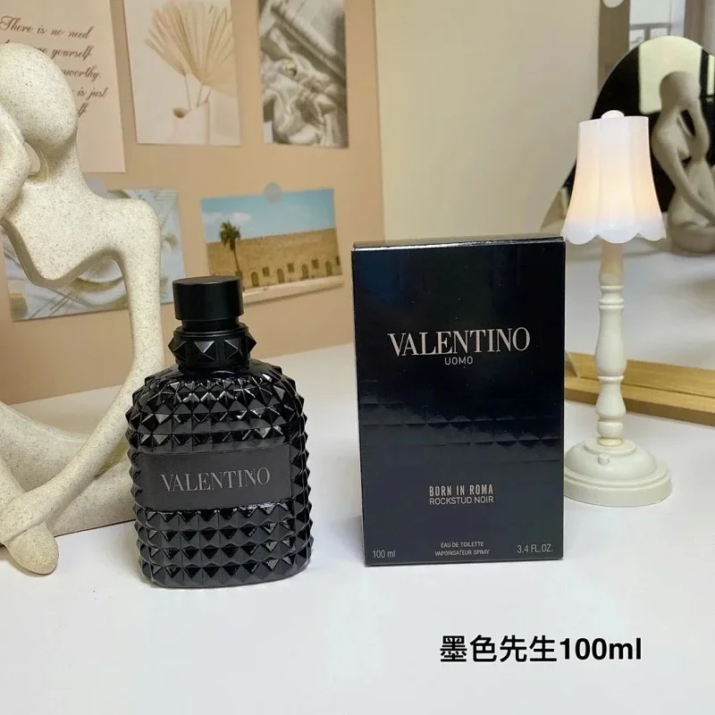 Valentino perfume bottle and packaging on a table with decorative items in the background
