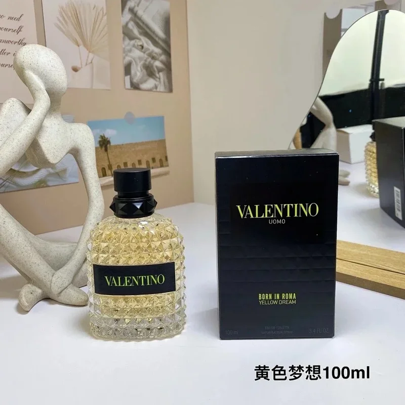 Perfume bottle and packaging on a table with decorative items in the background