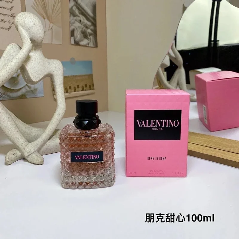 Valentino perfume bottle and packaging on a table with decorative items in the background.