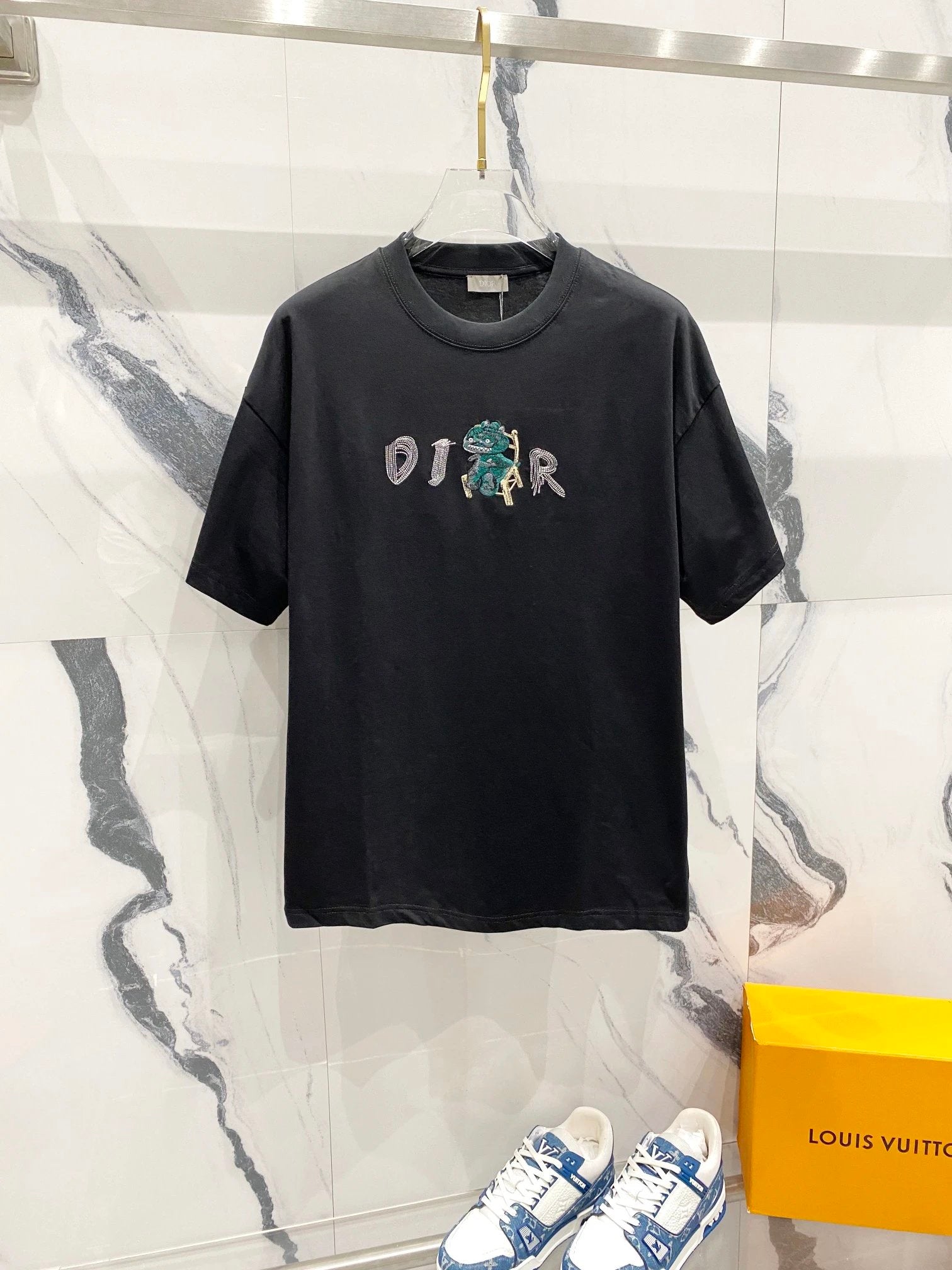 Black t-shirt with '019' design on a marble wall background
