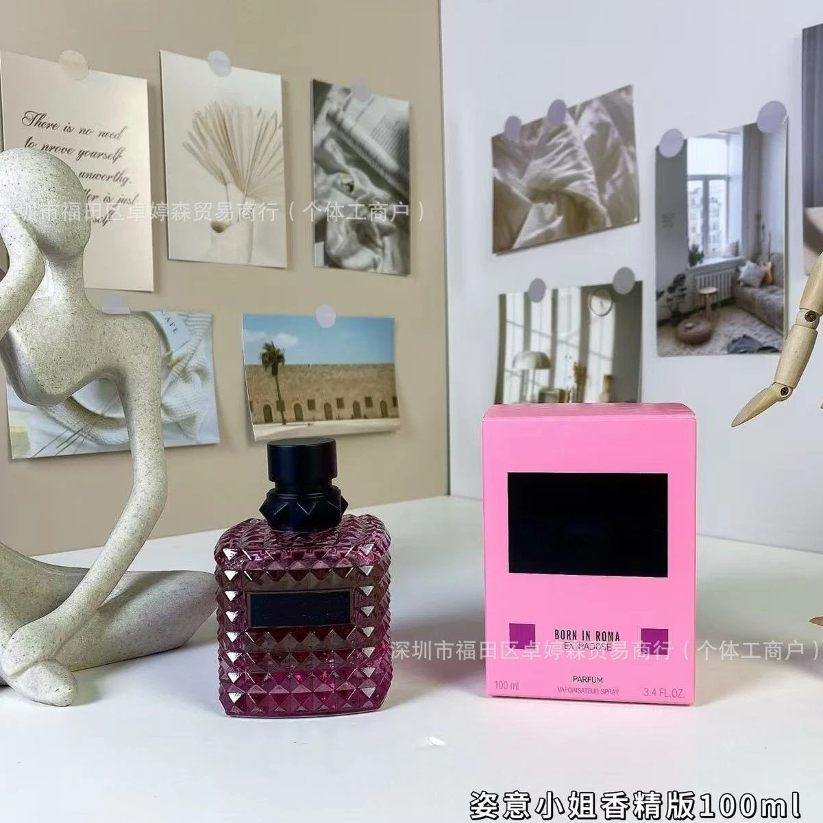 Valentino perfume bottle and packaging on a surface with decorative elements.