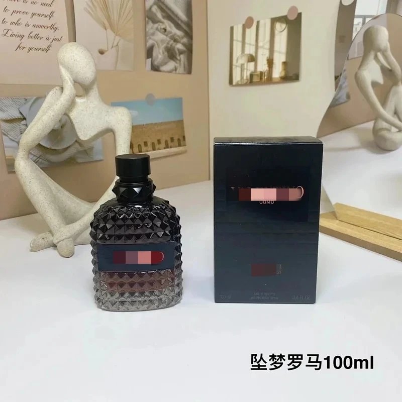 Perfume bottle and packaging on a white surface with decorative items in the background