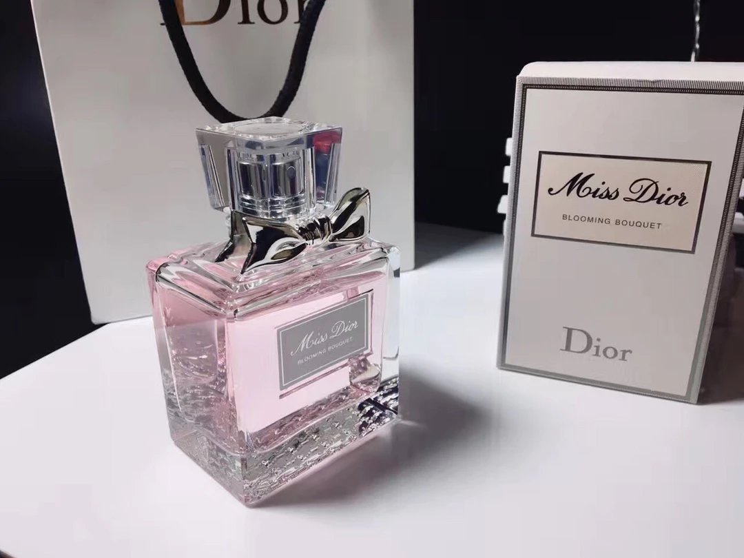 Dior perfume bottle and packaging on a white surface